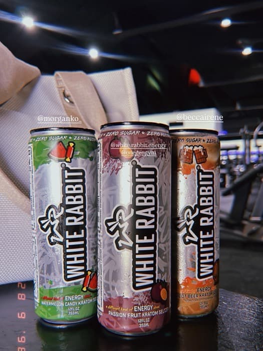Three flavours of White Rabbit Energy lined up on a gym floor